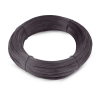 There is a coil of black annealed wire on the white ground